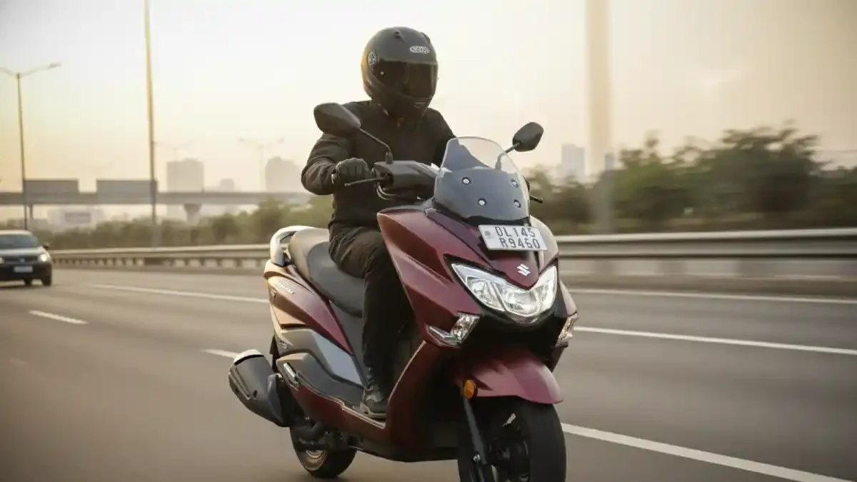 Suzuki Burgman Street 125 maxi-scooter running on a scenic highway.