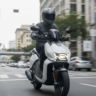 Hero Vida V1 electric scooter being ridden on a city road.