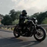 Kawasaki Eliminator cruiser bike being ridden on a scenic highway.