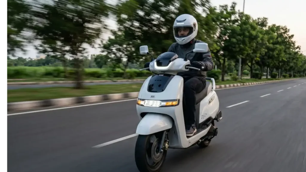 TVS iQube Electric scooter running on a city road with a rider.