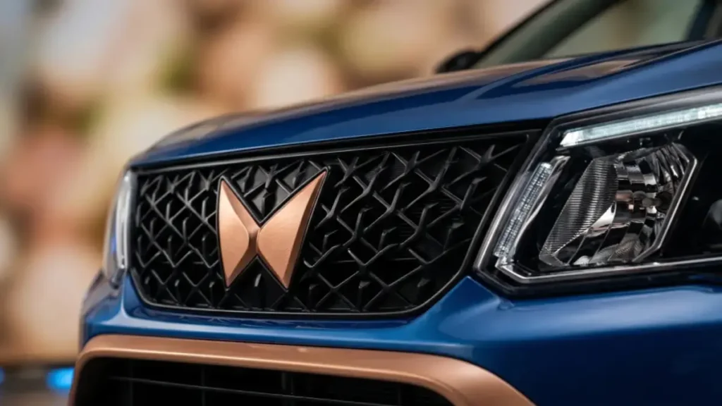 Close-up of Mahindra XUV400 EV front design and copper logo.