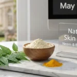 Fresh neem leaves and besan in a bowl on a stylish desk representing a natural face pack.