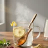 A steaming glass of hot water on a stylish desk representing a healthy morning habit.