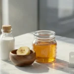 Fresh milk, honey, and banana on a stylish desk representing organic ingredients for a winter face pack.