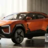 Mahindra BE 6 Electric SUV on a stylish desk showcasing its futuristic coupe design.