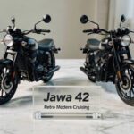Jawa 42 Bike on a stylish desk showcasing both front profile and rear dual-exhaust design.