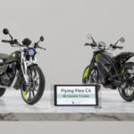Royal Enfield Flying Flea C6 on a stylish desk showcasing both front girder fork and rear single-seat profile design.