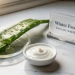 Fresh aloe vera leaf and a bowl of thick curd arranged on a stylish desk representing organic winter face pack ingredients.