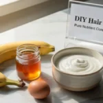 Fresh banana, honey, yogurt, and an egg arranged on a stylish desk representing organic hair mask ingredients.