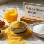 Raw suji, desi ghee, sugar, and assorted dry fruits arranged on a stylish desk representing traditional halwa ingredients.